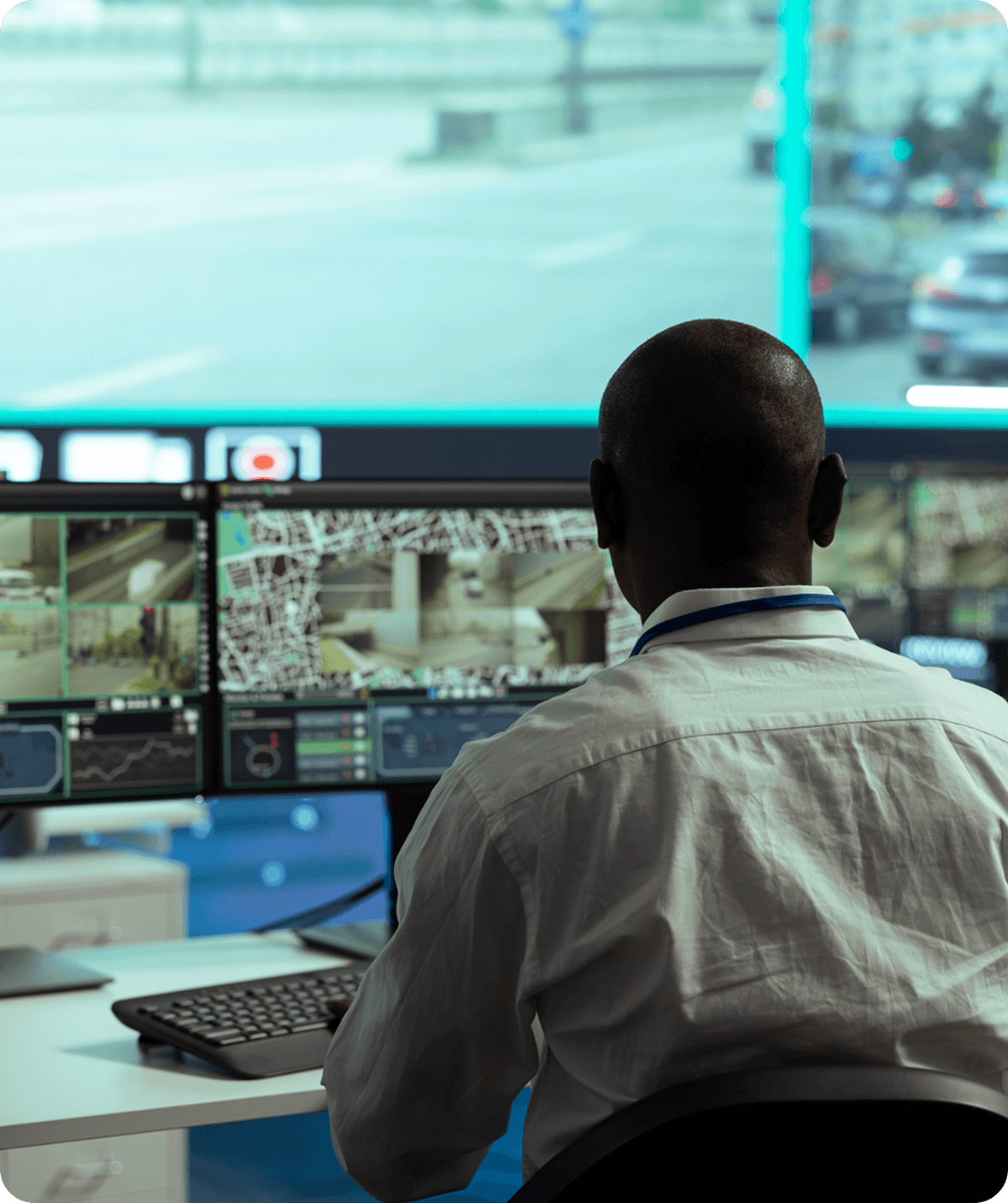 Man monitoring security screens