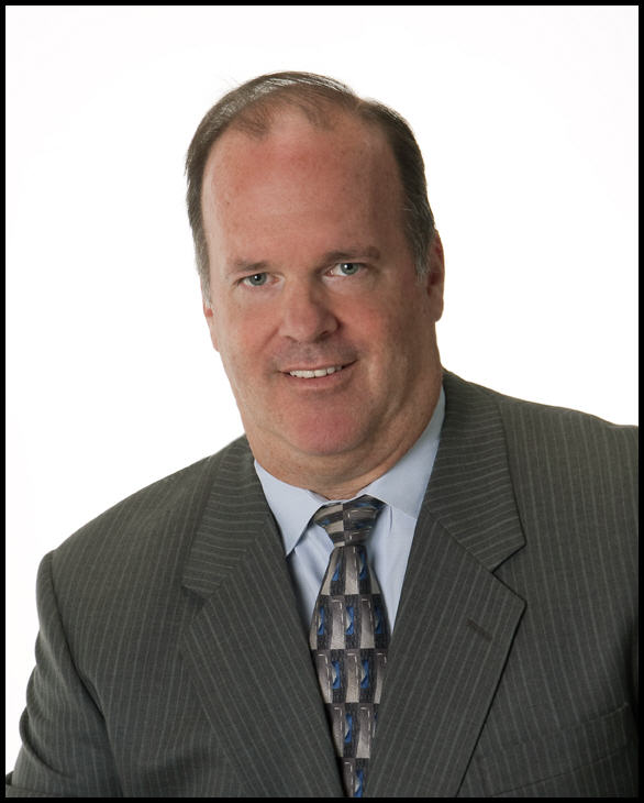Professional man in a business suit with a patterned tie.