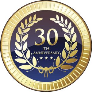 A 30th anniversary emblem with gold laurel wreaths and stars on a dark background.